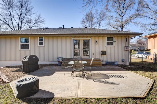 rear view of property with a patio, french doors, and fence