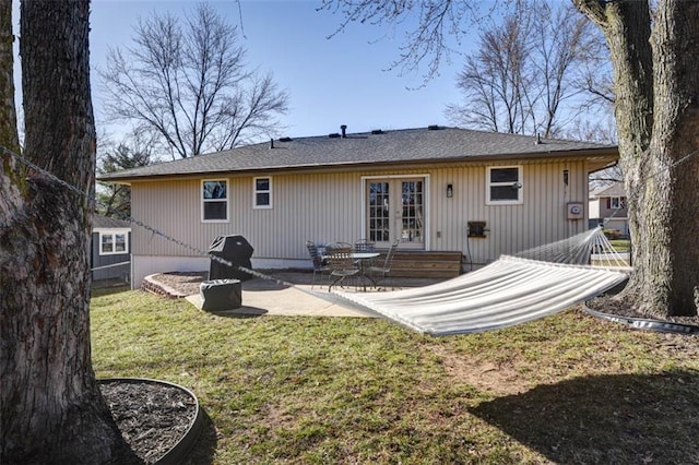 back of property featuring a patio, a yard, and french doors