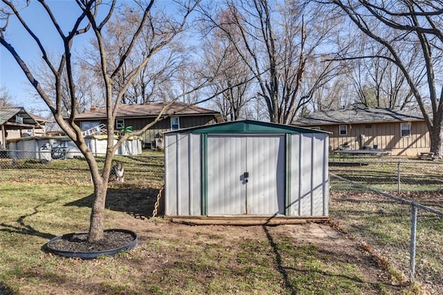 view of shed featuring fence