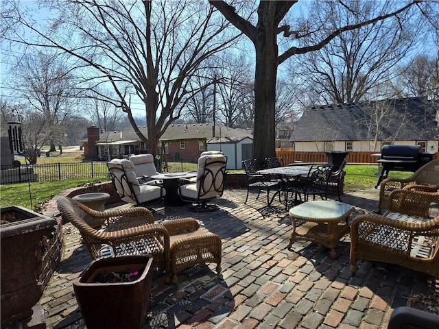 view of patio featuring a fenced backyard, an outdoor fire pit, a storage shed, an outdoor structure, and outdoor dining area