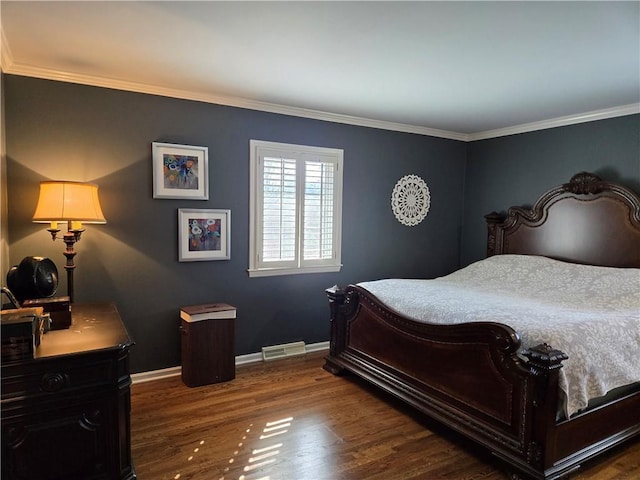 bedroom featuring visible vents, ornamental molding, baseboards, and wood finished floors