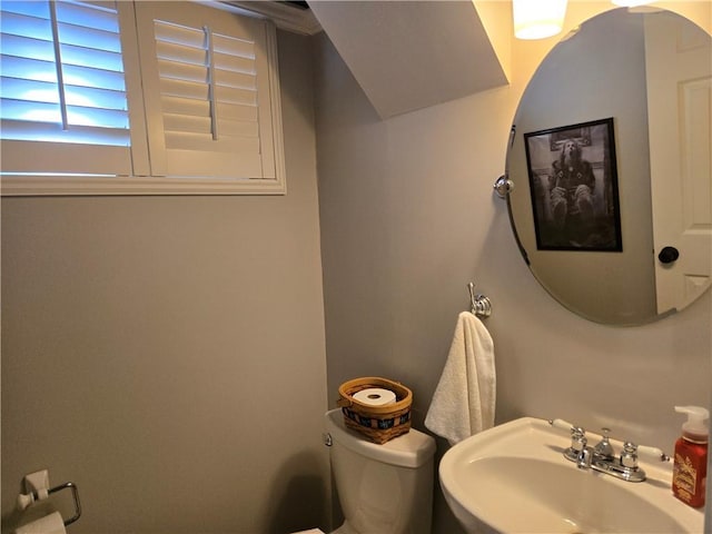 bathroom with toilet and a sink