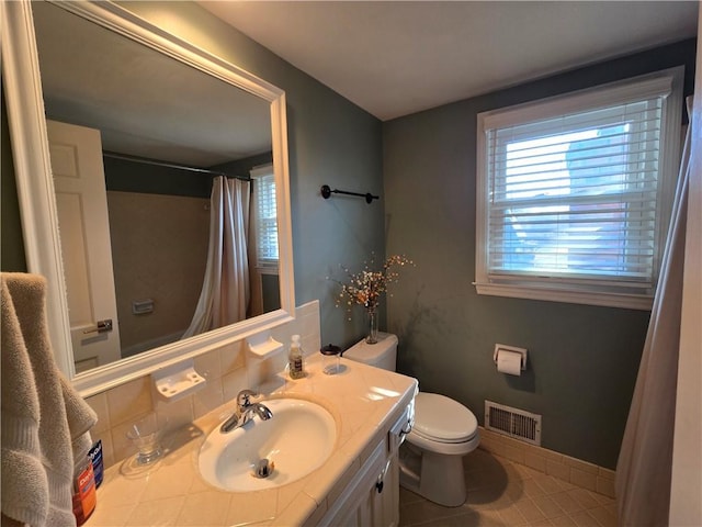 bathroom with tile patterned flooring, visible vents, baseboards, toilet, and vanity