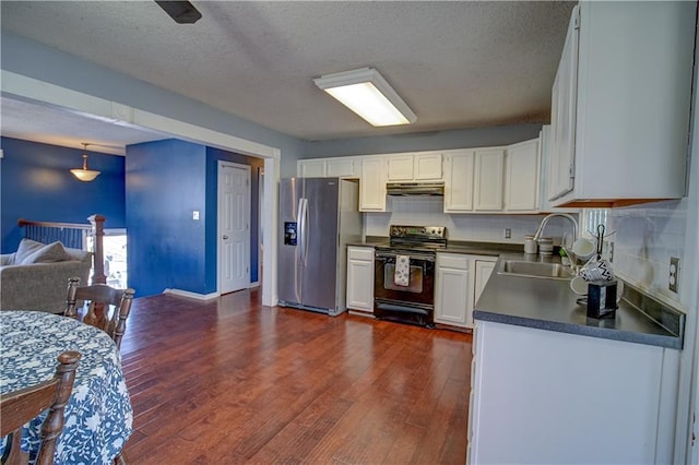 kitchen featuring dark countertops, black range with electric cooktop, under cabinet range hood, stainless steel refrigerator with ice dispenser, and a sink