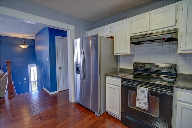 kitchen with dark wood-style flooring, black electric range, stainless steel refrigerator with ice dispenser, under cabinet range hood, and dark countertops