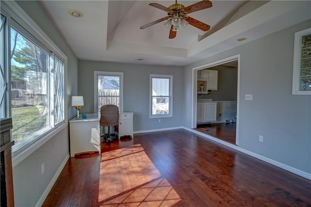 office with hardwood / wood-style flooring, vaulted ceiling, baseboards, and ceiling fan