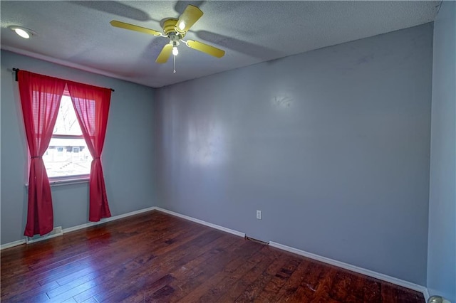 spare room featuring visible vents, a textured ceiling, and wood finished floors