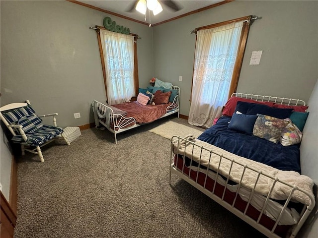 carpeted bedroom with baseboards, a ceiling fan, and crown molding