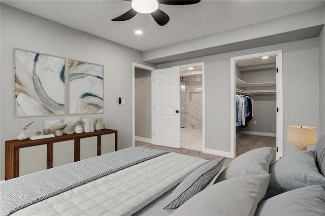 carpeted bedroom with a spacious closet, baseboards, recessed lighting, ensuite bathroom, and a closet