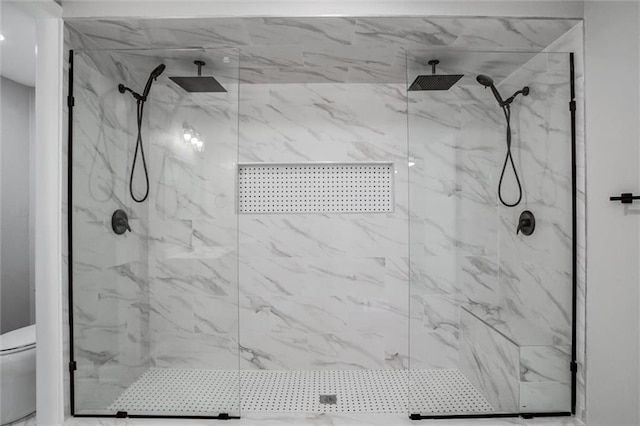 full bath with a marble finish shower and toilet