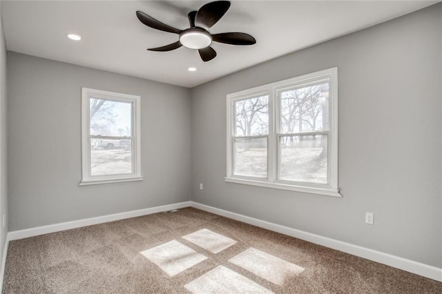 unfurnished room with baseboards, a ceiling fan, and carpet flooring