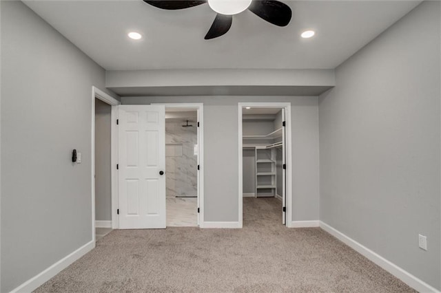 unfurnished bedroom with a spacious closet, recessed lighting, baseboards, and carpet floors