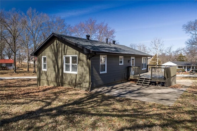 back of house featuring a patio and a deck