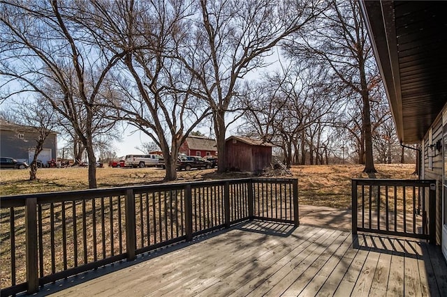 deck featuring a storage unit and an outdoor structure