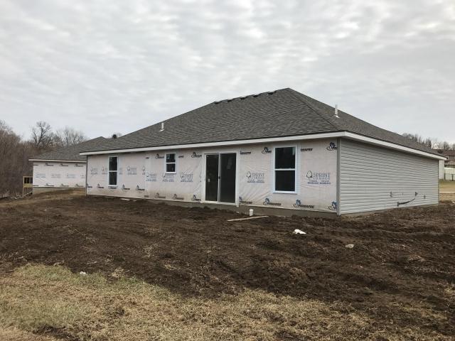 back of property featuring a shingled roof