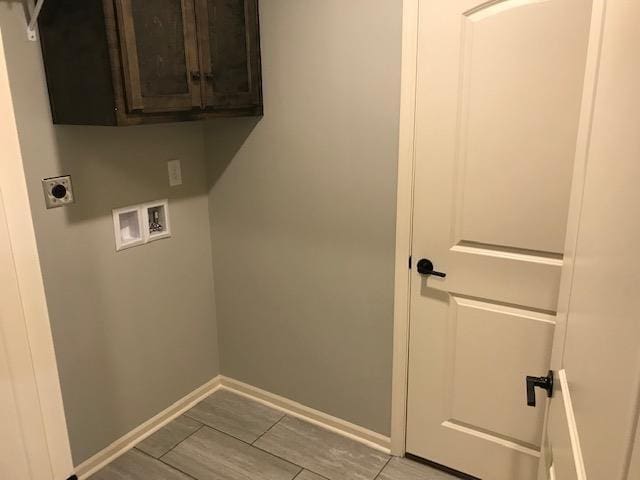 laundry area featuring baseboards, cabinet space, hookup for an electric dryer, and washer hookup