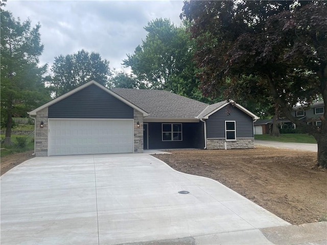 2101 N 31st Ter, Saint Joseph, MO 64506 - ranch-style home featuring stone siding, concrete driveway, and a garage