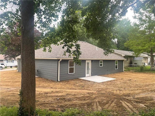 2101 N 31st Ter, Saint Joseph, MO 64506 - rear view of property with a patio and a shingled roof