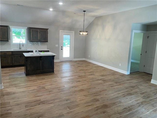 2101 N 31st Ter, Saint Joseph, MO 64506 - kitchen with lofted ceiling, light wood finished floors, light countertops, a center island, and a chandelier
