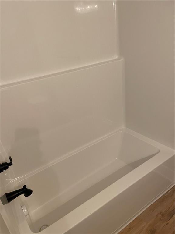 2101 N 31st Ter, Saint Joseph, MO 64506 - full bath featuring a tub, wood finished floors, and a shower
