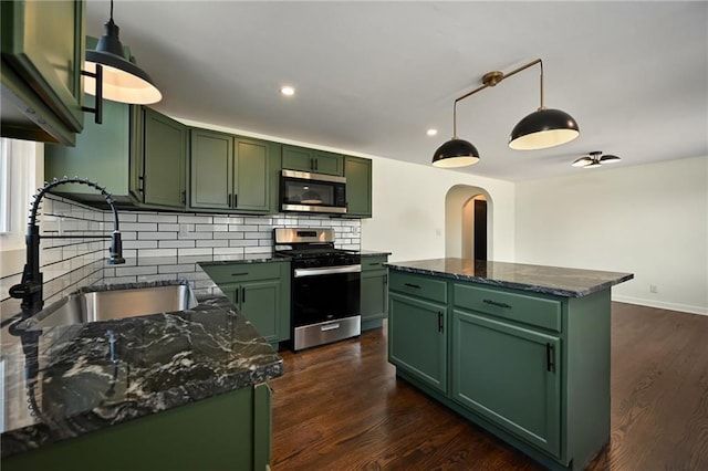 kitchen featuring a sink, appliances with stainless steel finishes, and green cabinets