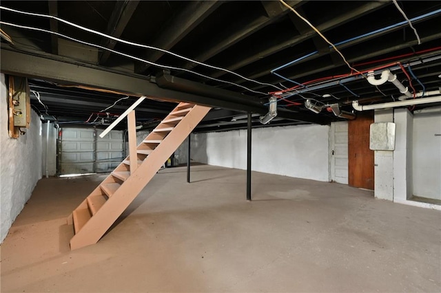 unfinished basement featuring stairs