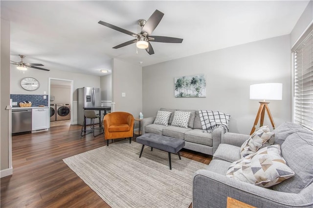 living area with washing machine and clothes dryer, dark wood-type flooring, and a ceiling fan