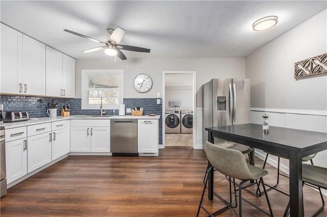 kitchen with a ceiling fan, a sink, separate washer and dryer, light countertops, and dishwasher