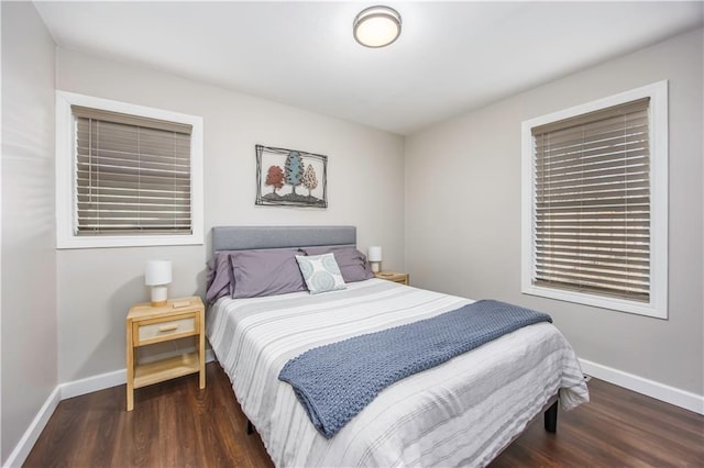 bedroom featuring baseboards and wood finished floors