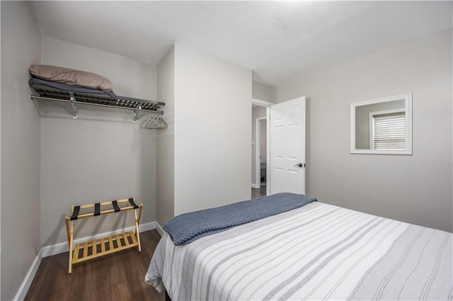 bedroom featuring wood finished floors and baseboards