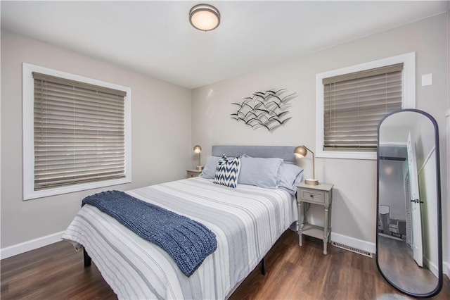 bedroom featuring wood finished floors and baseboards