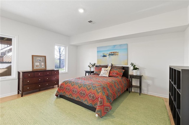 bedroom with baseboards, visible vents, and recessed lighting