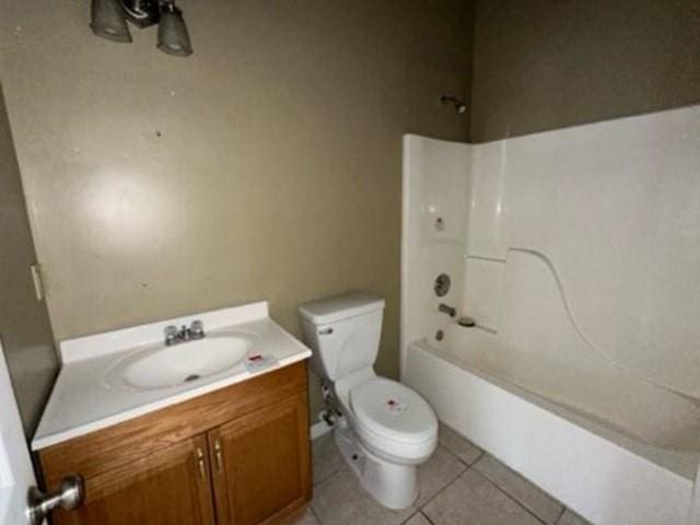 full bathroom featuring tile patterned flooring, toilet, vanity, and washtub / shower combination