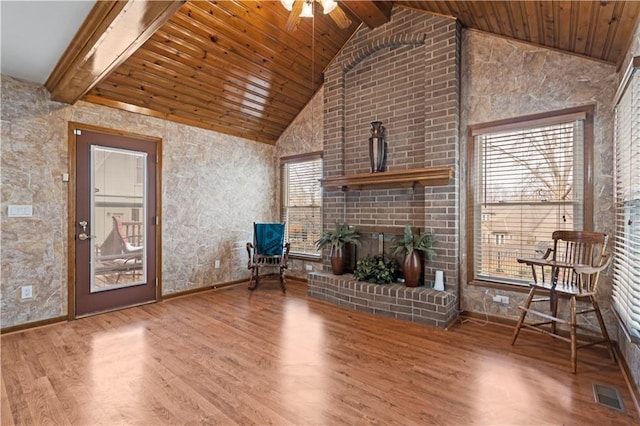 unfurnished room with a ceiling fan, wood finished floors, visible vents, beam ceiling, and wooden ceiling