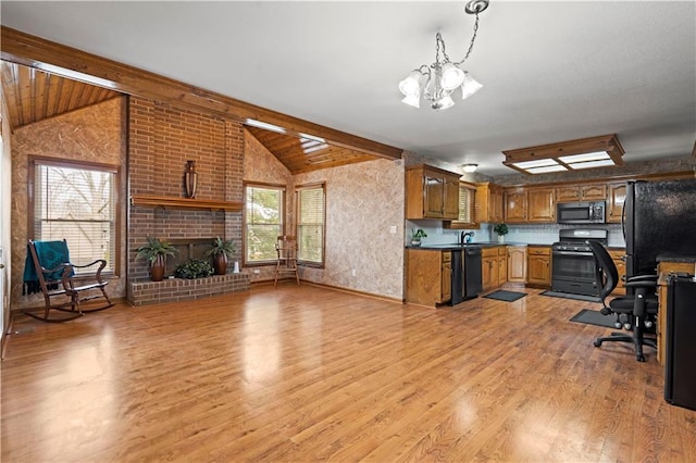 kitchen featuring brown cabinets, an inviting chandelier, lofted ceiling with beams, black appliances, and light wood-type flooring