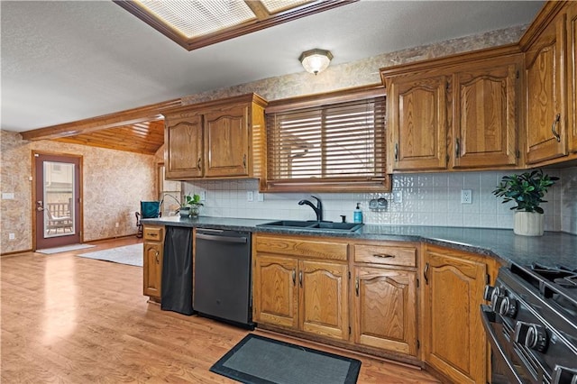 kitchen featuring black range with gas stovetop, light wood-type flooring, dishwashing machine, brown cabinetry, and a sink