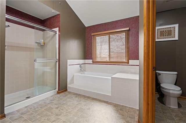 bathroom featuring toilet, a bath, and a stall shower