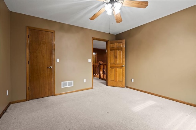 spare room featuring visible vents, baseboards, carpet, and a ceiling fan