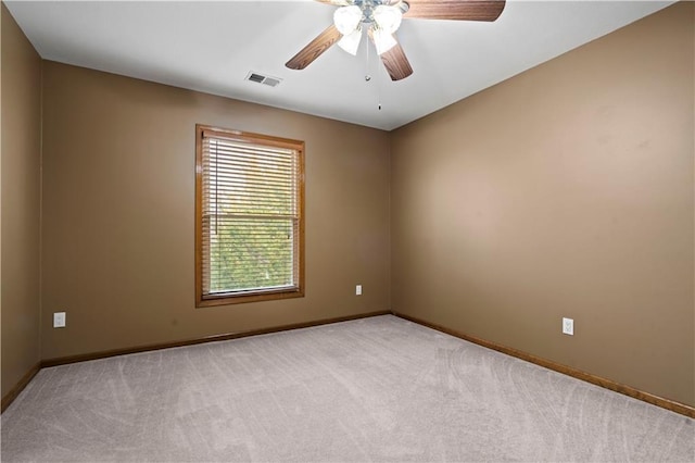 unfurnished room with baseboards, carpet, visible vents, and ceiling fan