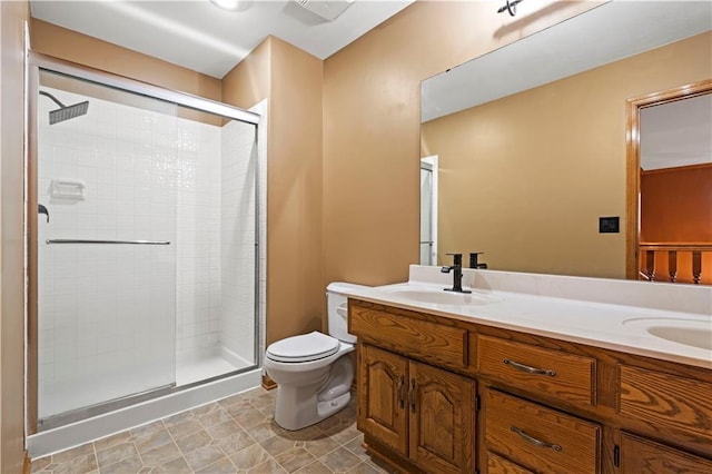 full bath featuring double vanity, toilet, a stall shower, and a sink