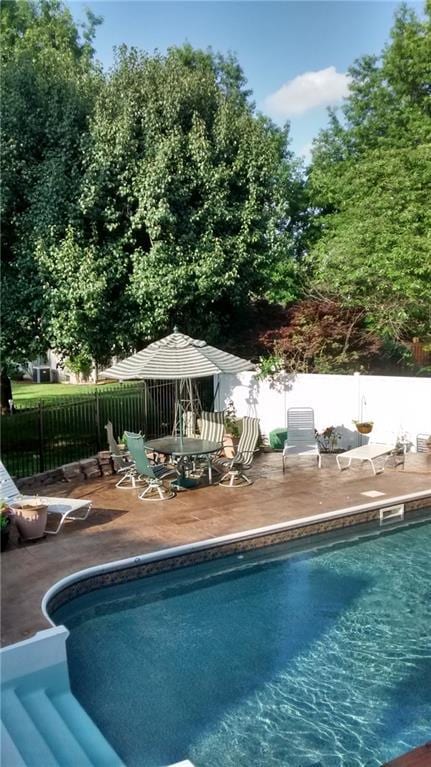 view of pool with a fenced in pool and fence