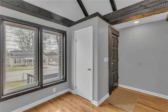 empty room with light wood-style floors and baseboards