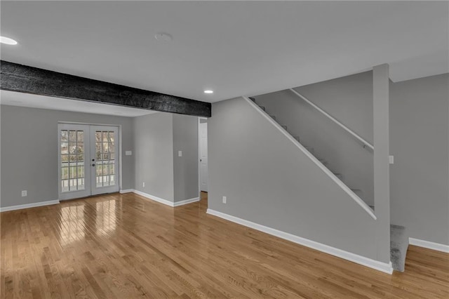 below grade area with recessed lighting, stairway, baseboards, and wood finished floors