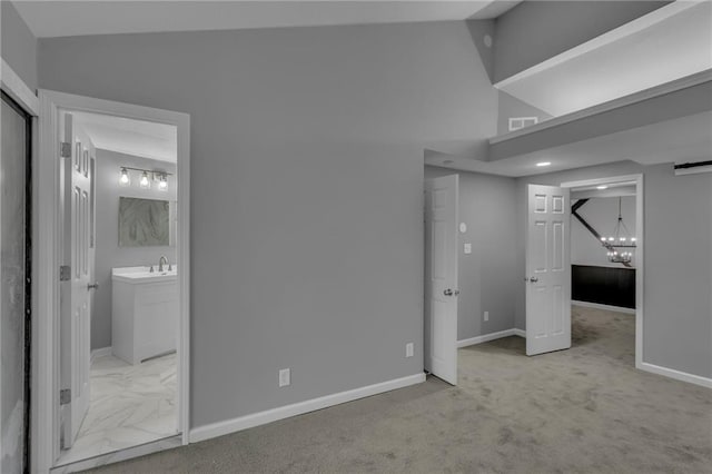 unfurnished bedroom featuring visible vents, baseboards, an inviting chandelier, and vaulted ceiling