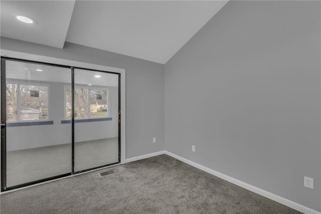 carpeted empty room with visible vents, recessed lighting, baseboards, and vaulted ceiling