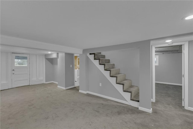 basement with recessed lighting, baseboards, carpet, and stairs