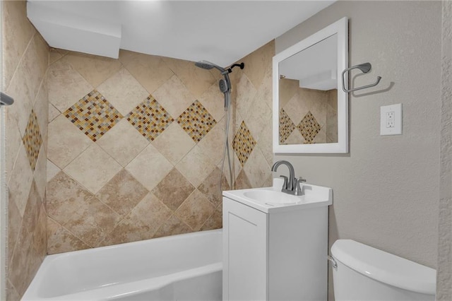 full bath featuring toilet, vanity, shower / bath combination, and a textured wall