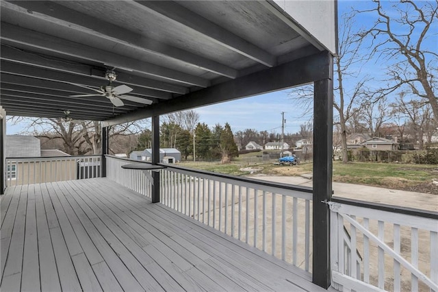 deck with an outdoor structure, a shed, and ceiling fan