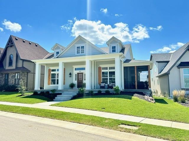 view of front of house with a front yard and a sunroom