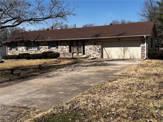 ranch-style home with brick siding, an attached garage, concrete driveway, and roof with shingles